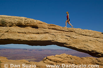 Hiker on Mesa Arch, Canyonlands National Park